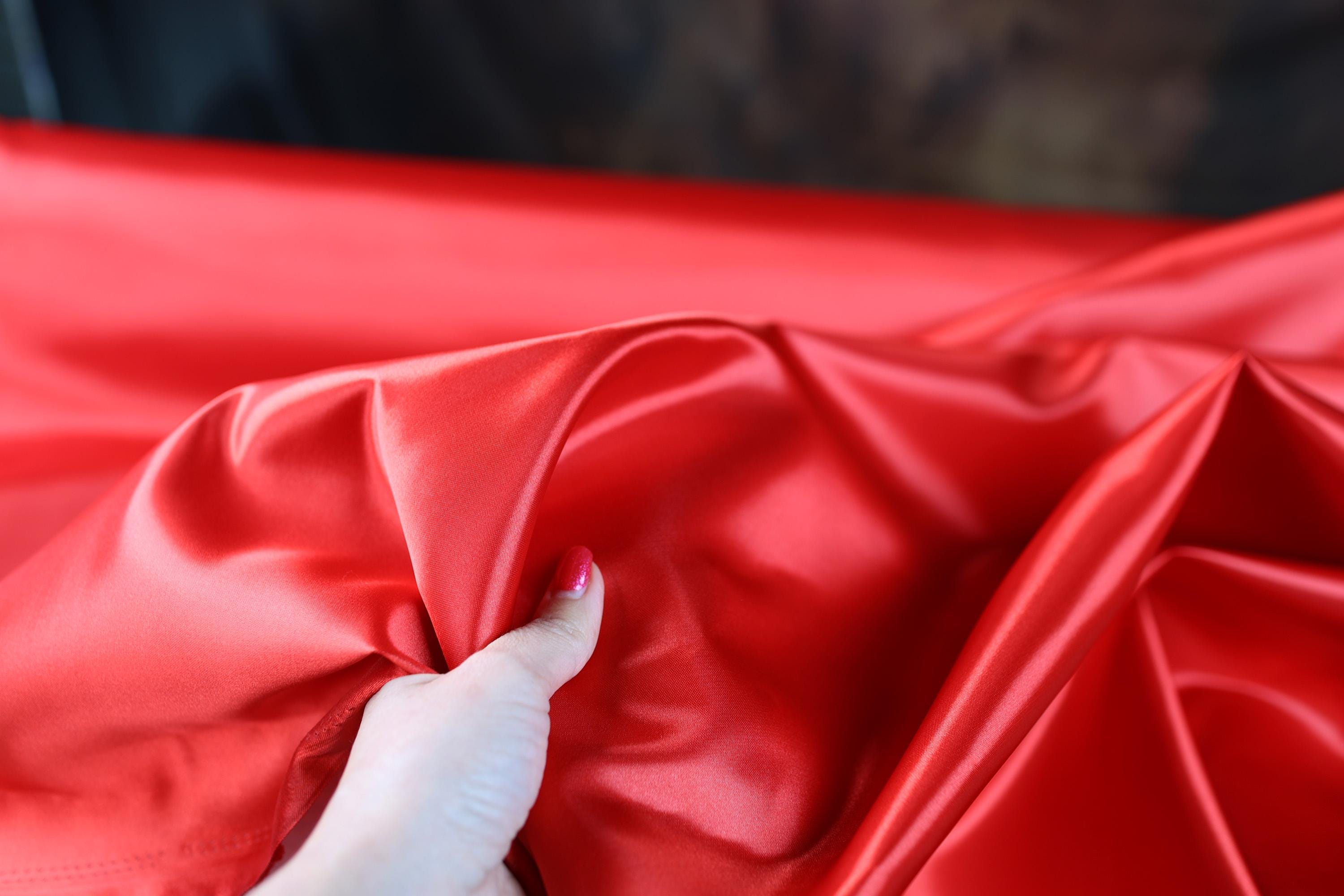 a person is holding a red cloth in their hand