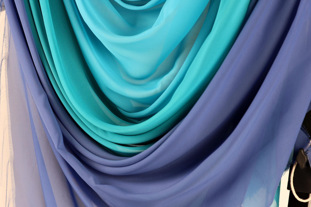 a close-up view of a collection of blue and purple fabric swatches, showcasing the different shades and textures of the materials.