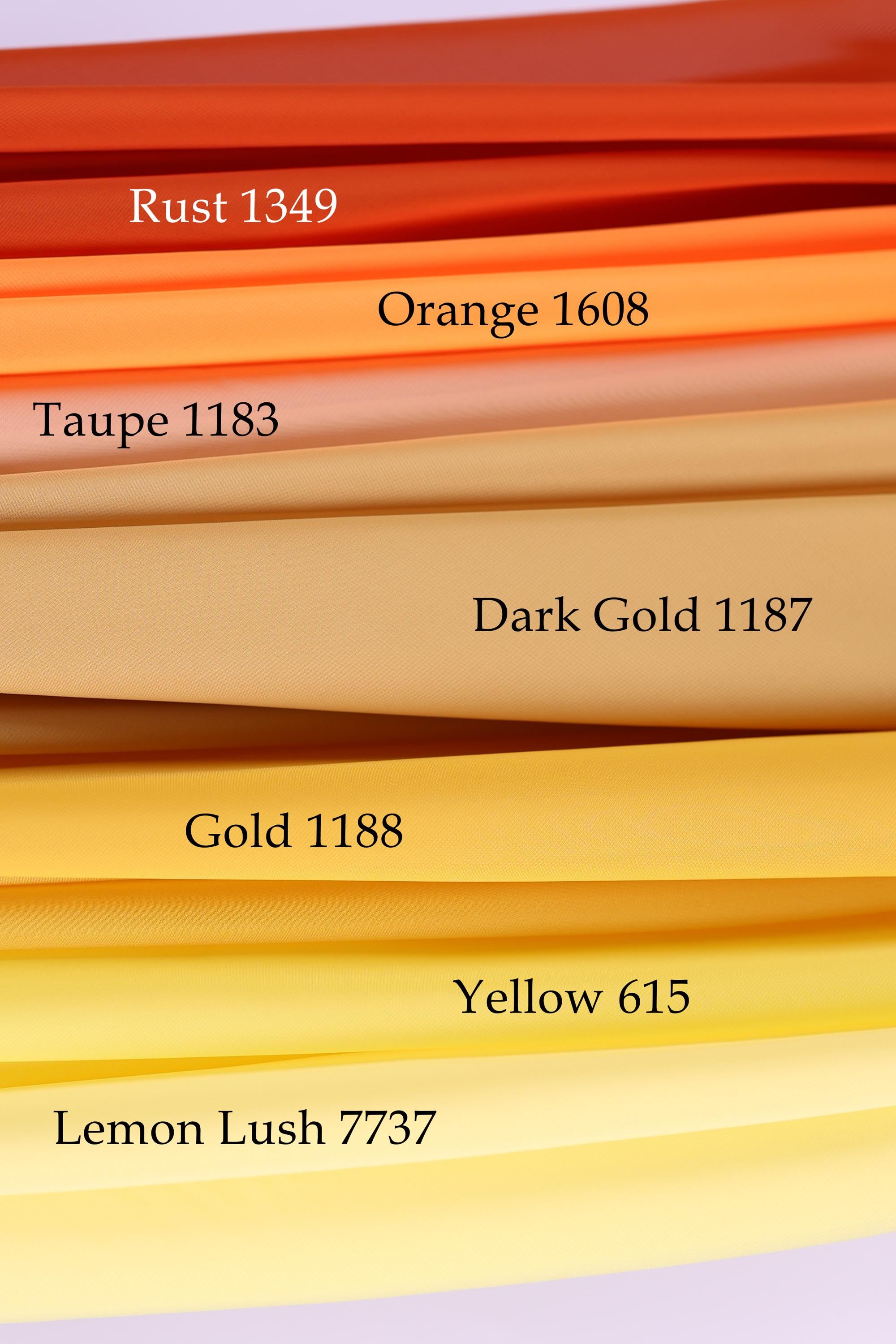 a collection of fabric swatches in various colors, including rust, orange, taupe, dark gold, yellow, and lemon.