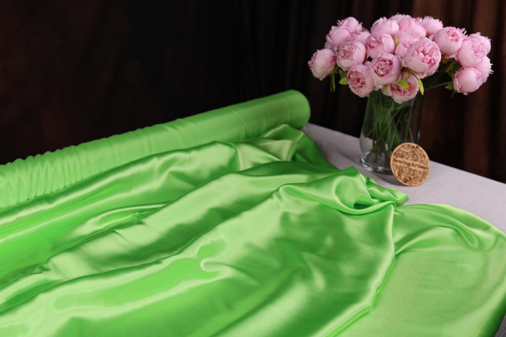 a vase filled with pink flowers sitting on top of a table