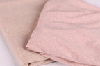 two pieces of fabric, one in a light pink color and the other in a darker pink color, both with a glittery texture.