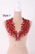 A mannequin wearing a red sequined neckline with a floral pattern.