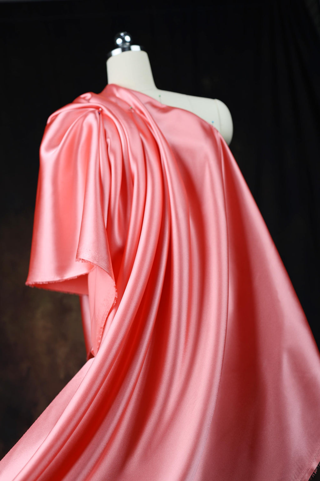 a dress on a mannequin with a red cape on top of it