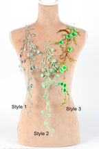 a mannequin with three different styles of green floral embroidery on its bust.