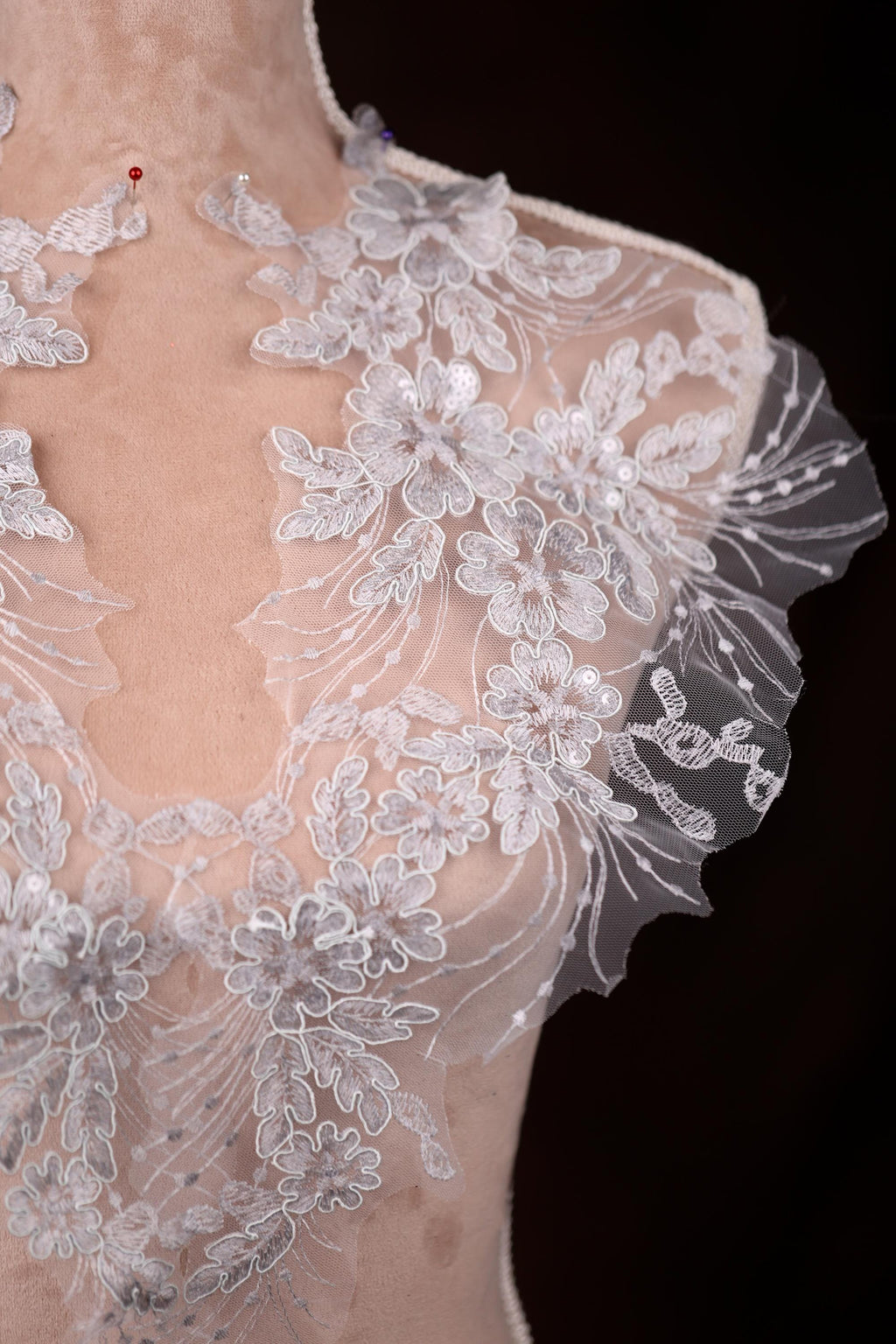 a white wedding dress with a sheer back