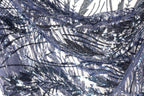 The image is a close-up view of a fabric with a dark blue and black sequin pattern. The fabric appears to be made of a sheer material, with the sequins creating a textured and intricate design.