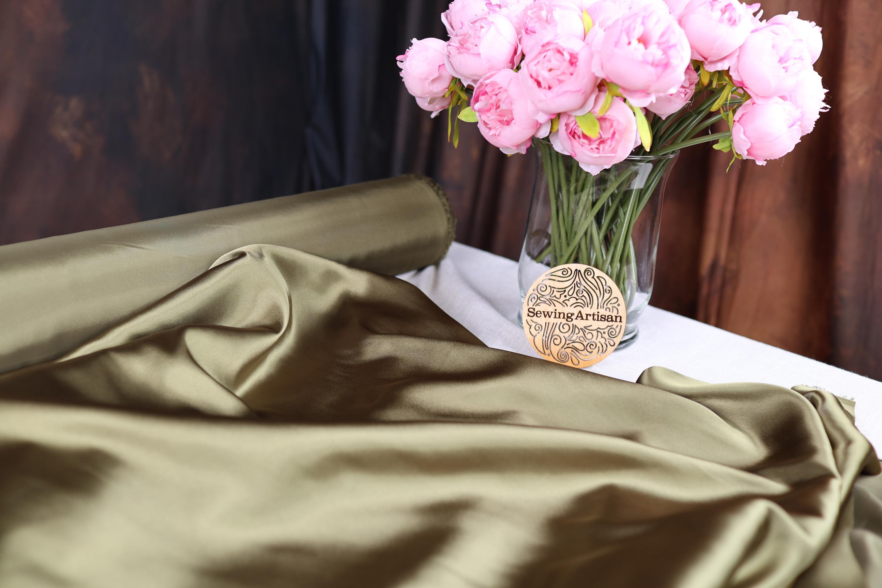 a vase filled with pink flowers on top of a table