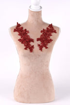 A mannequin with red embroidered flowers on its bust area.