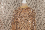 a mannequin wearing a gold sequin dress with a beige collar.