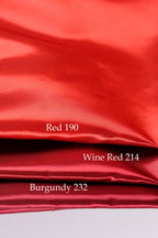 The image is a close-up of a red fabric, with three distinct shades of red: Red 190, Wine Red 214, and Burgundy 232.