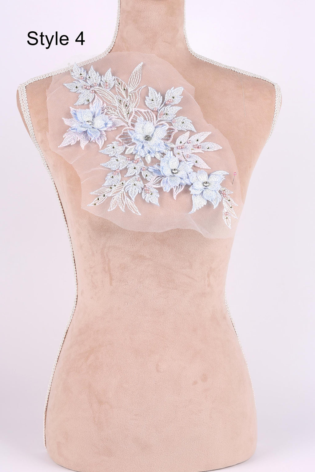 A mannequin with a floral embroidered patch on its back.