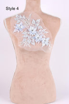 A mannequin with a floral embroidered patch on its back.
