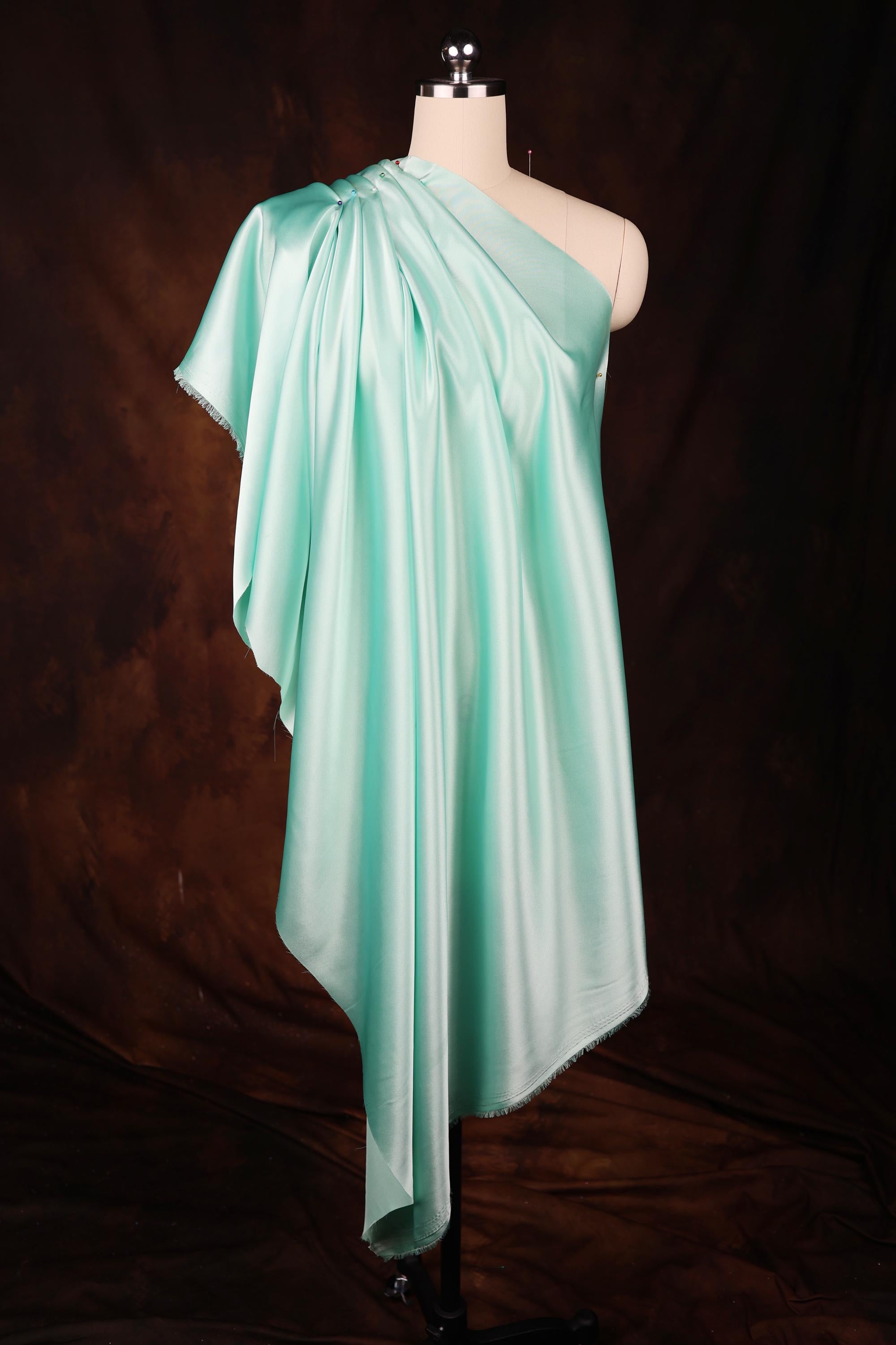 a dress on a mannequin on a black background