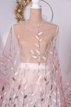 A mannequin wearing a pink and white floral dress with a sheer overlay.