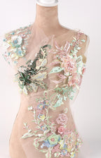 A mannequin wearing a dress with a floral pattern on the bodice and sleeves.