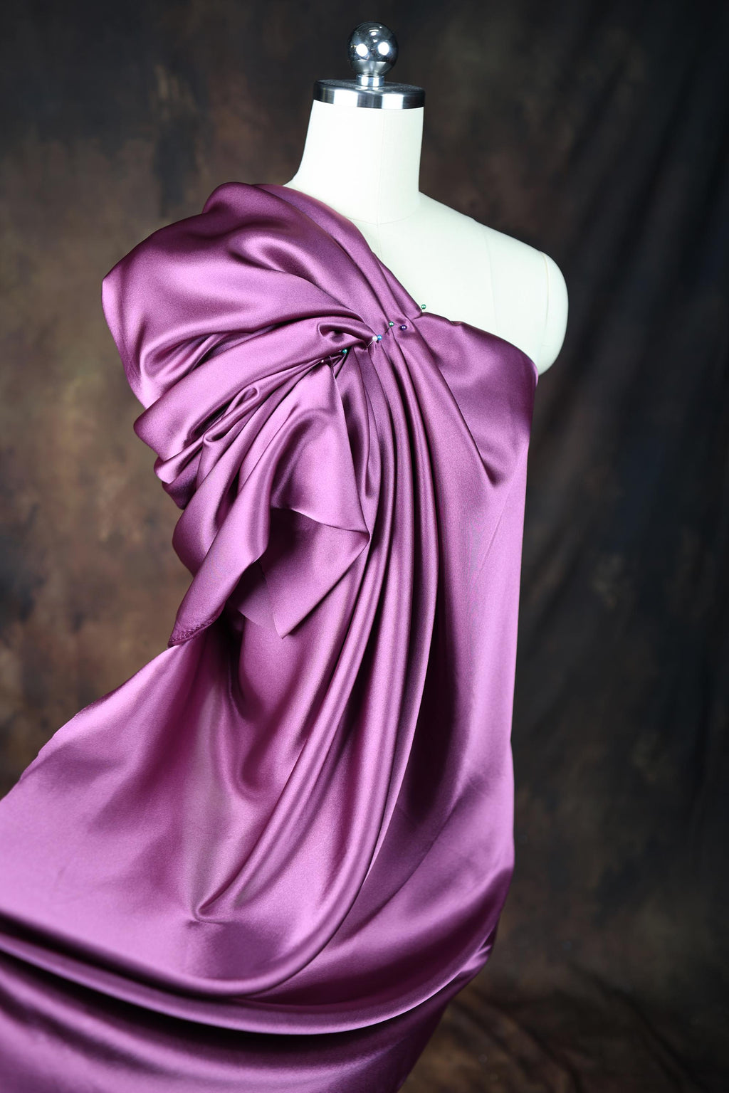 a mannequin is dressed in a purple dress