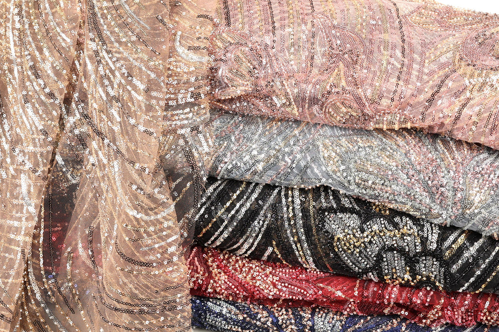 a collection of colorful, sequined fabric pieces stacked on top of each other.