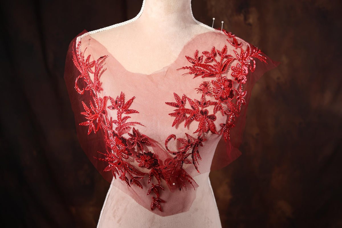 a mannequin wearing a red dress with flowers on it