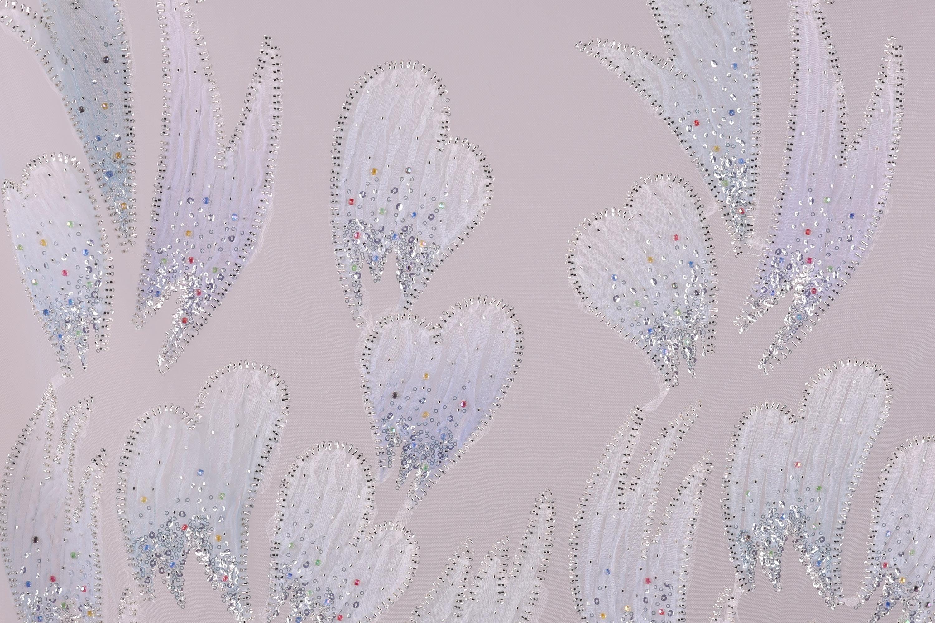 a pattern of white and silver glittering leaves or flowers against a light purple background.