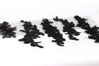 a collection of black lace pieces arranged on a white background.