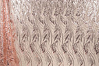 a close-up view of a fabric with a repeating pattern of leaves and flowers in shades of brown and beige. The pattern is intricate and detailed, creating a visually appealing and textured appearance.