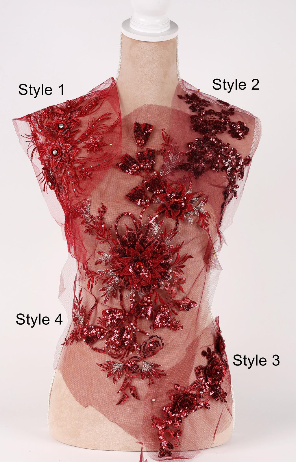 A mannequin wearing a red dress with intricate floral and sequin designs.