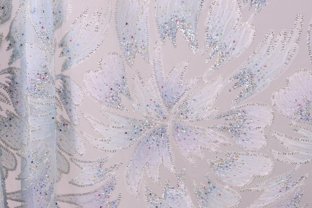 a close-up view of a fabric with a floral pattern, adorned with small, colorful beads or sequins that add a decorative touch.