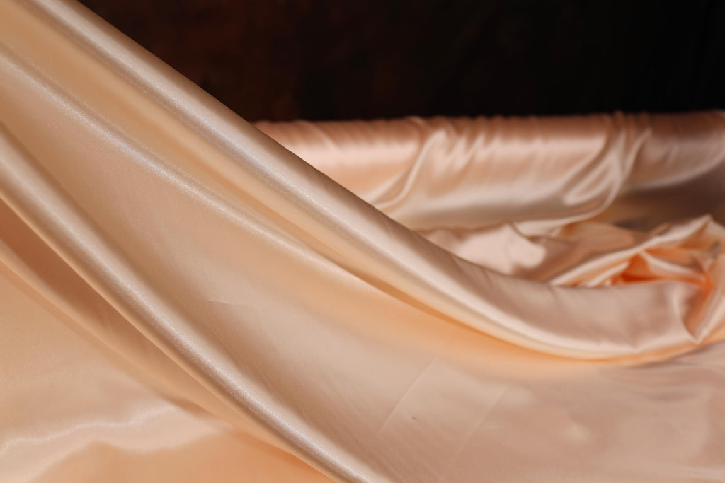 a close up of a white satin material