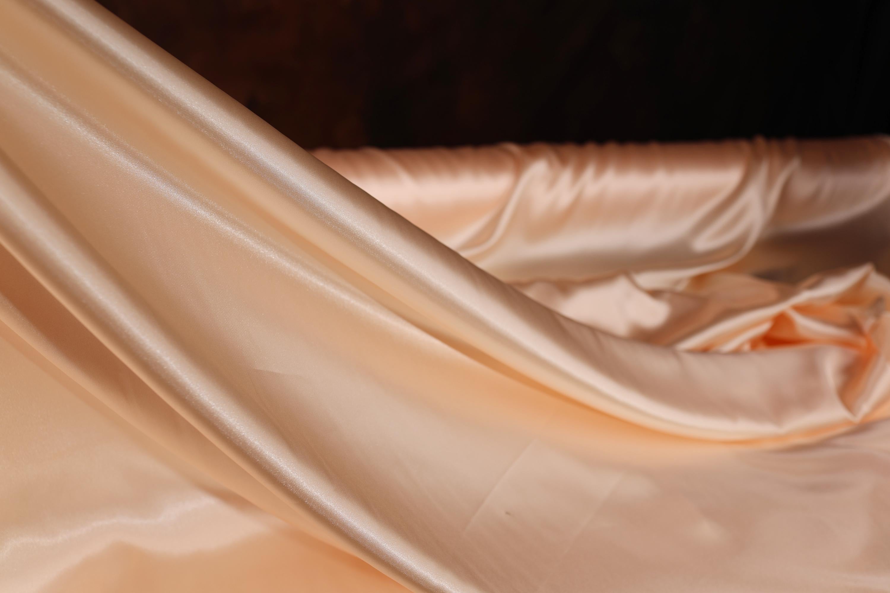 a close up of a white satin material
