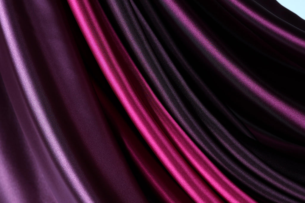 a close-up view of a fabric with a mix of purple and pink hues, creating a visually striking and vibrant pattern.
