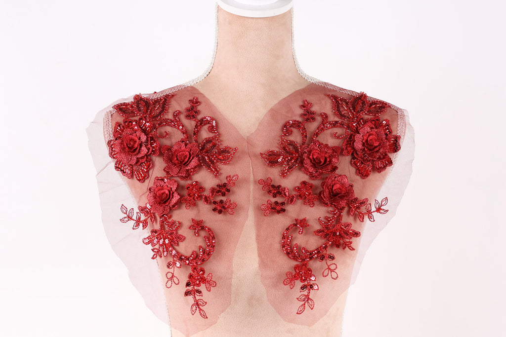 A mannequin with red floral embroidery on its shoulders.
