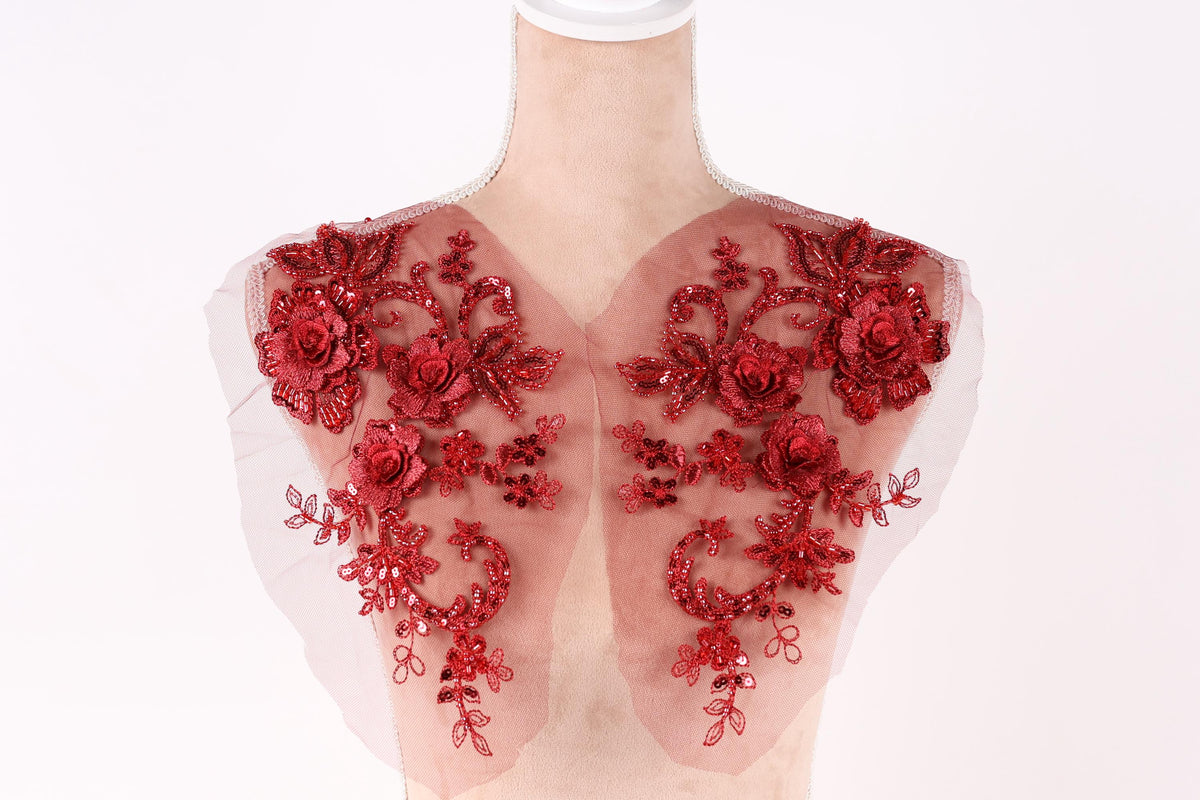A mannequin with red floral embroidery on its shoulders.
