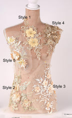 A mannequin with various floral and lace designs on its body, including different styles of dresses or garments.