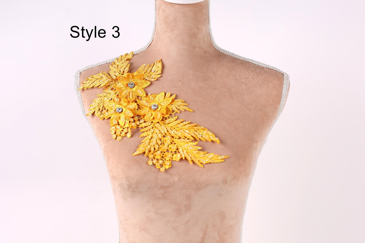 A mannequin with a decorative gold leaf design on its shoulder.