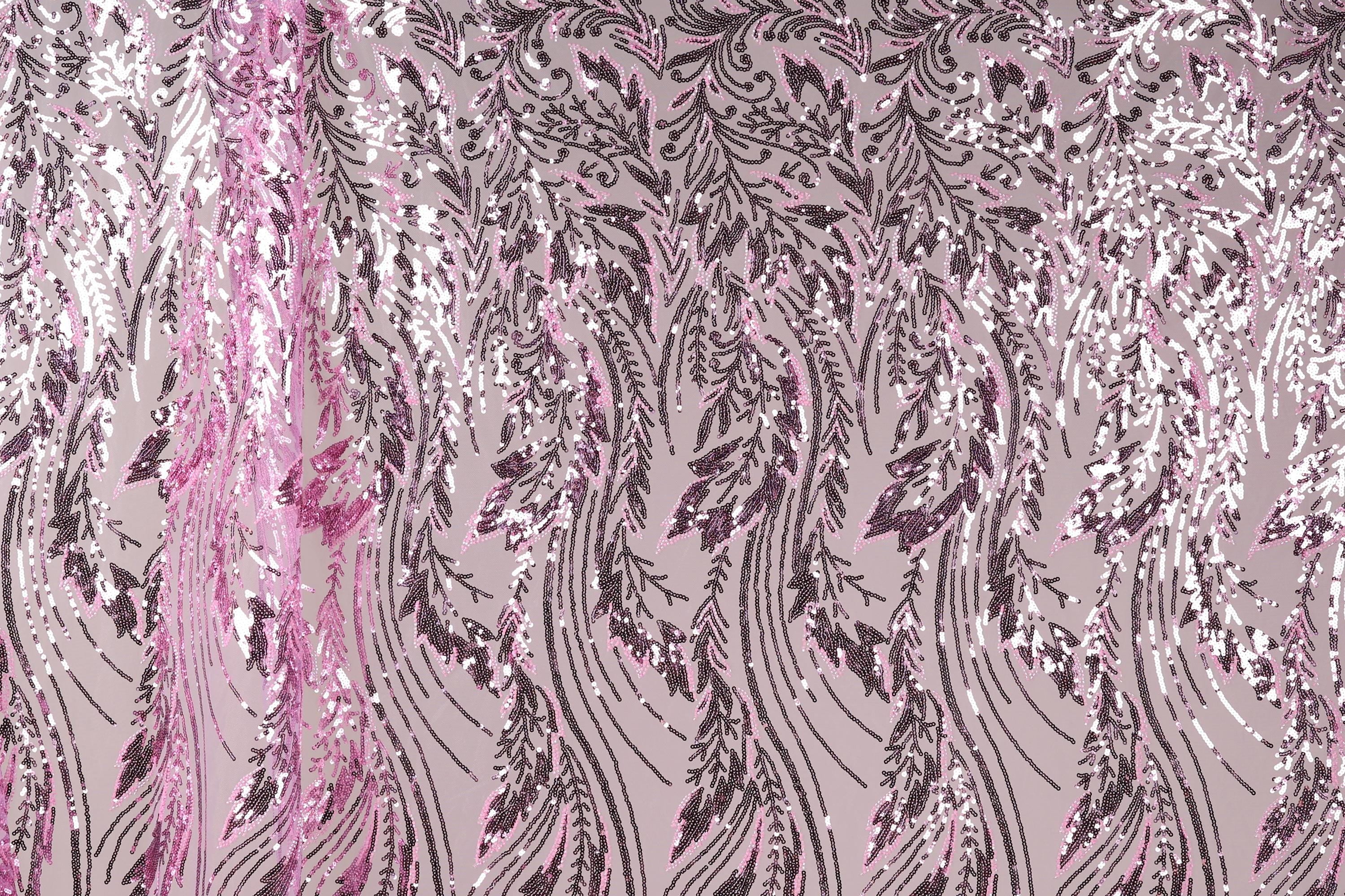a close-up view of a fabric with a repeating pattern of pink and black sequin designs. The pattern consists of various shapes and sizes of sequins arranged in a diagonal line across the fabric, creating a visually striking and intricate design.