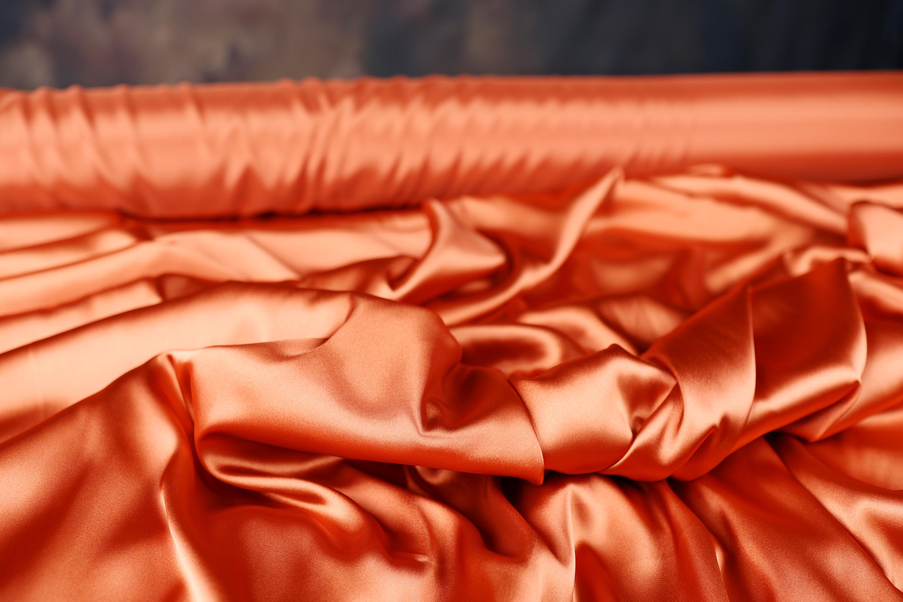 a close up of an orange satin material