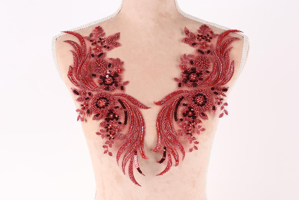 A mannequin torso with red sequin and floral embellishments on the bust area.