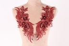 A mannequin torso with red sequin and floral embellishments on the bust area.