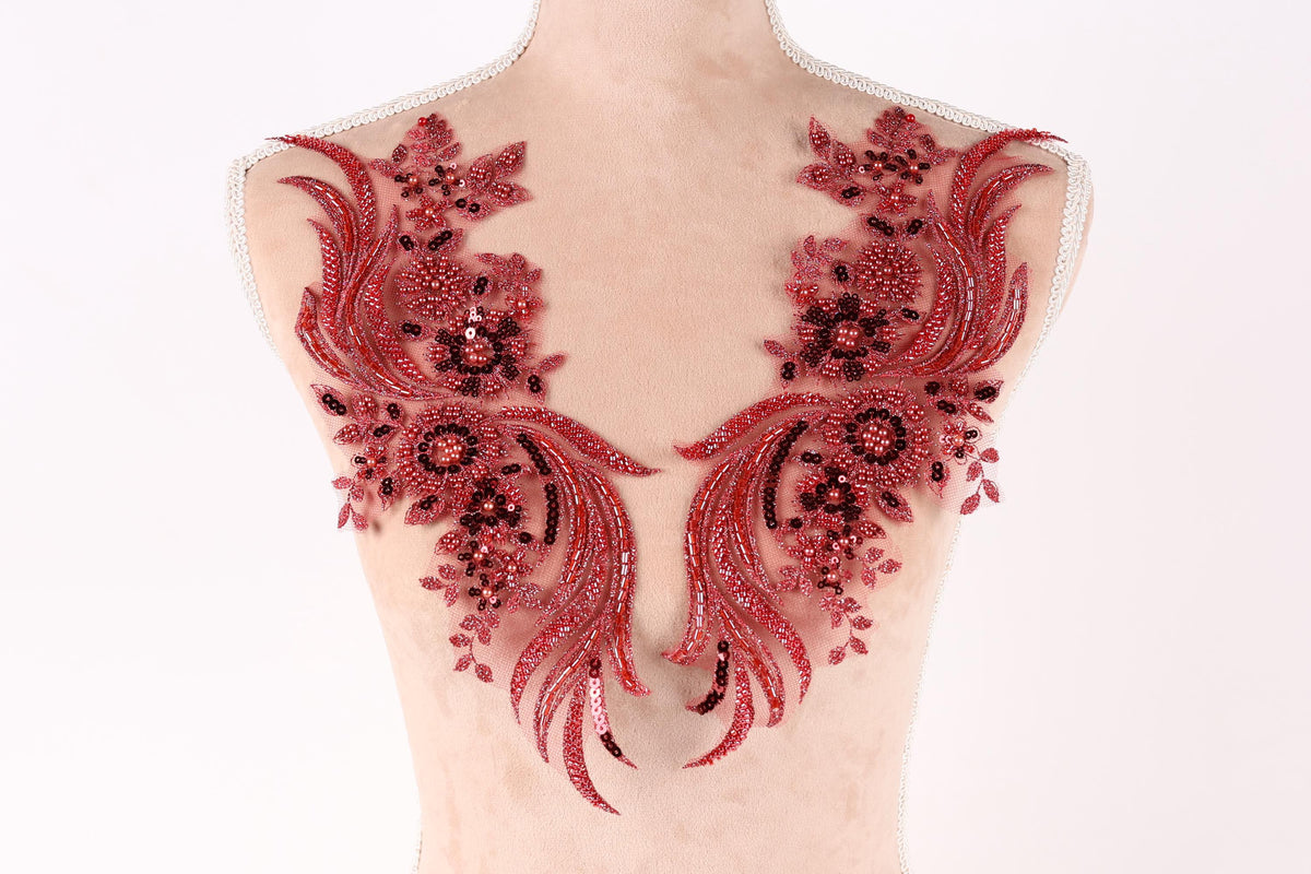 A mannequin torso with red sequin and floral embellishments on the bust area.