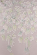 a repeating pattern of white and green floral designs on a light pink background.