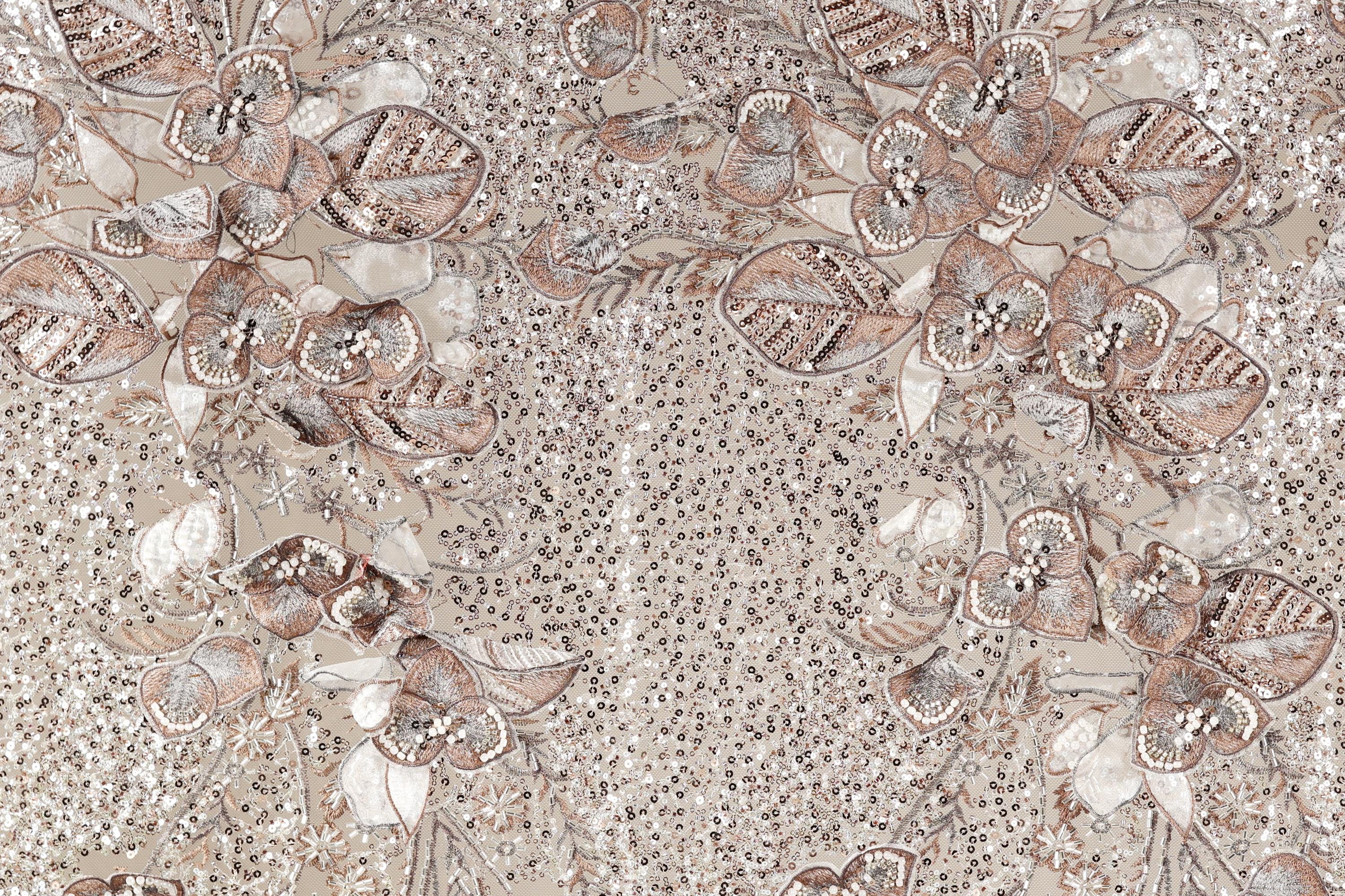 a detailed and intricate floral pattern with various shades of brown and beige, accented by small white dots. The pattern appears to be a collage of multiple images, creating a visually striking and textured composition.