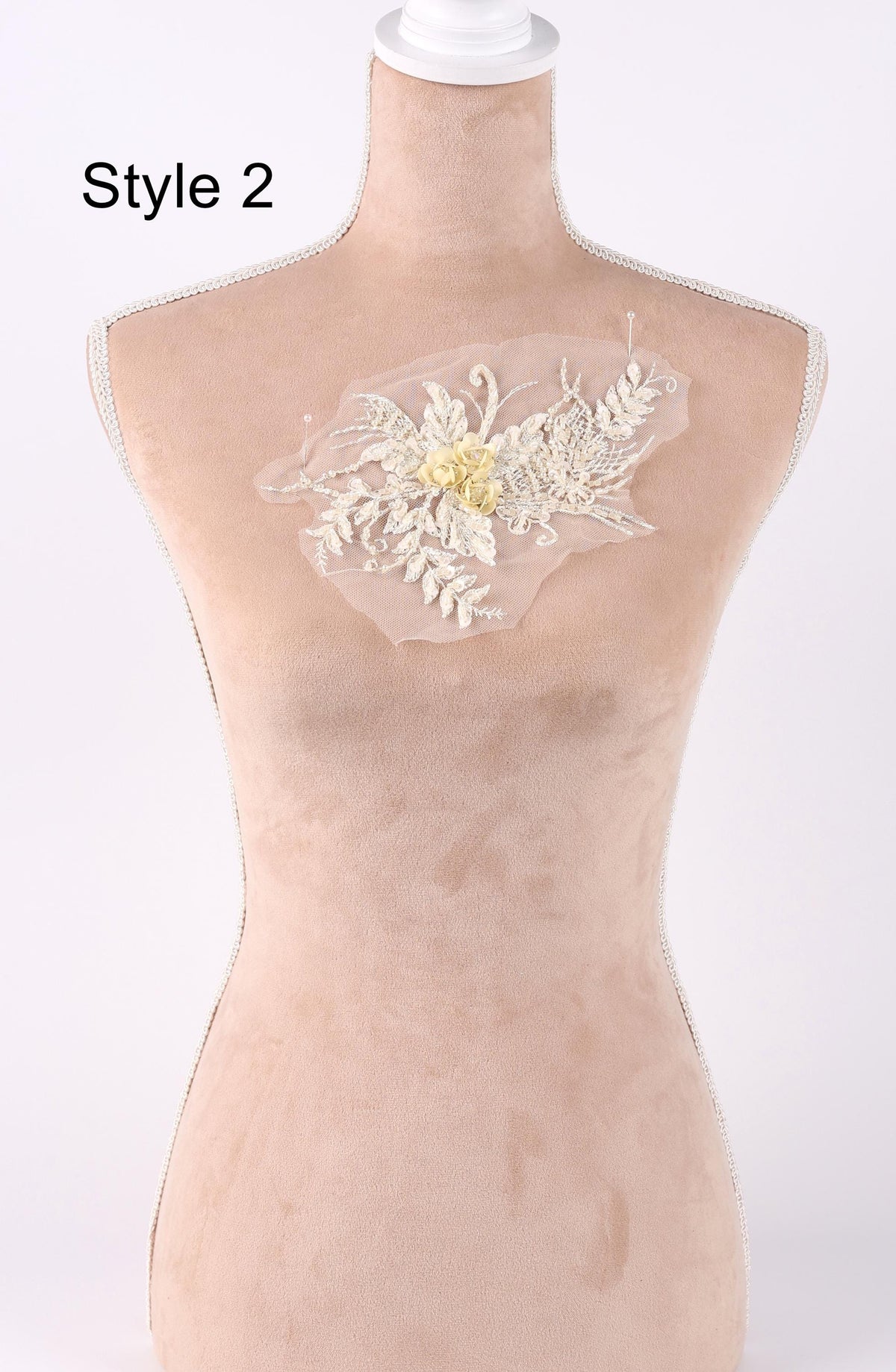 A mannequin with a floral embroidered patch on its chest.
