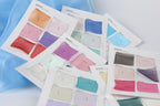 a collection of fabric swatches or color samples, each with a label or description, likely used for design or fashion purposes.