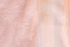The image is a close-up of a fabric with a pink and white color scheme, featuring a textured and sparkly appearance.