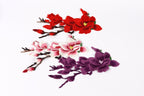 three different types of flowers, including red, pink, and purple flowers, arranged in a visually appealing manner.