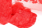 The image is a close-up of a red fabric with a floral pattern, featuring a lot of texture and detail.