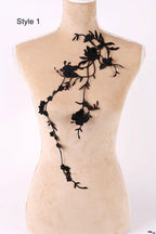 A mannequin with a floral embroidered piece of clothing on its bust.