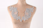 A mannequin with a decorative lace collar on its bust.