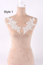 A mannequin with a beige body and white lace flowers on the shoulders, displayed against a white background.