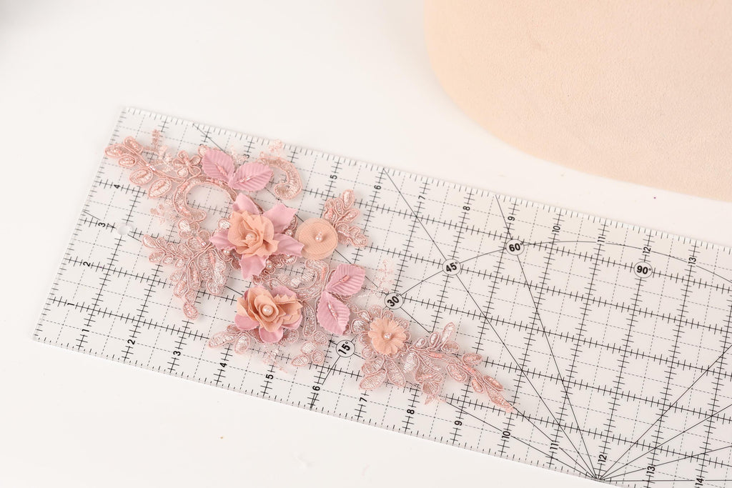 a clear ruler with a floral design on it, placed on a white surface.